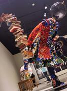 I really like the dynamism he shows, with the girl carefully maintaining balance with the weight of knowledge behind her. (Yinka Shonibare CBE: "Planets in My Head" exhibit. Likely one of the _Blanacing Knowledge_ works.)